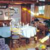 The lounge/dining area is a comfortable room of dark woods and sunshine. 